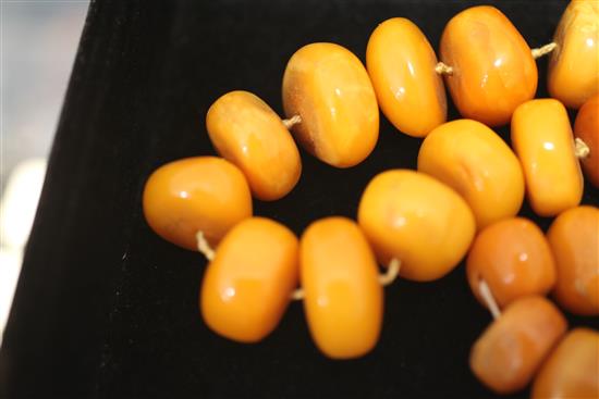 A single strand disc shaped amber bead necklace and matching bracelet, necklace 18.5in.